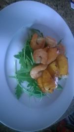 Sauteed shrimp and carmelized peaches on arugula
